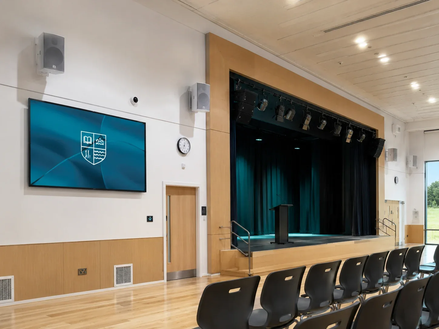 School hall with display, speakers and stage lighting