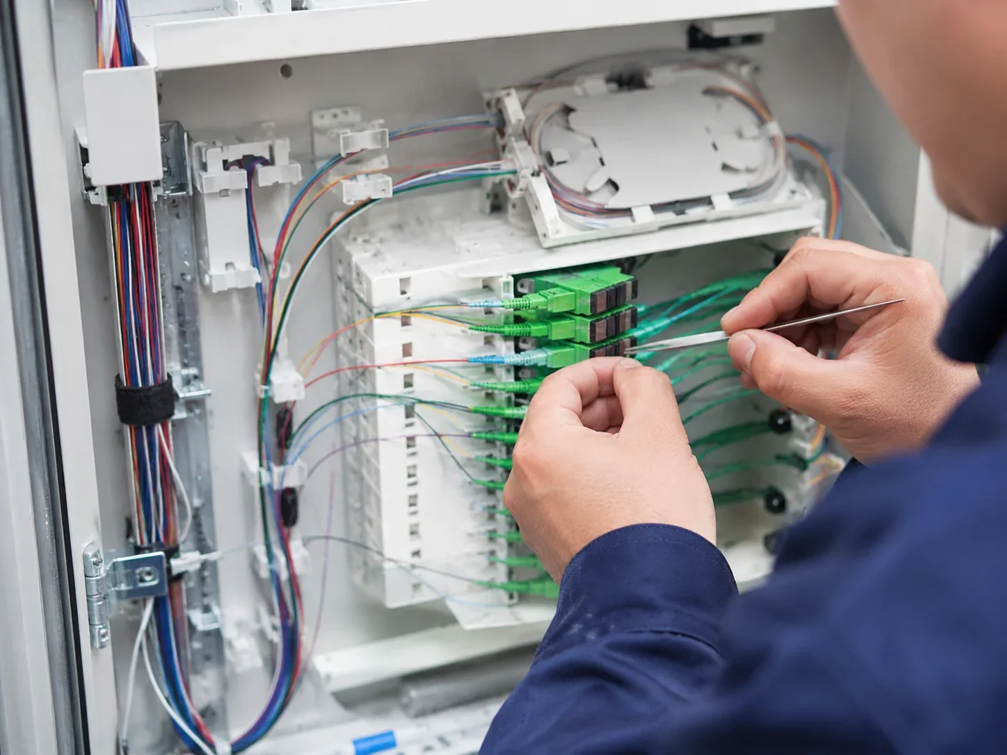 Technician carrying out fibre optic cabling termination and splicing