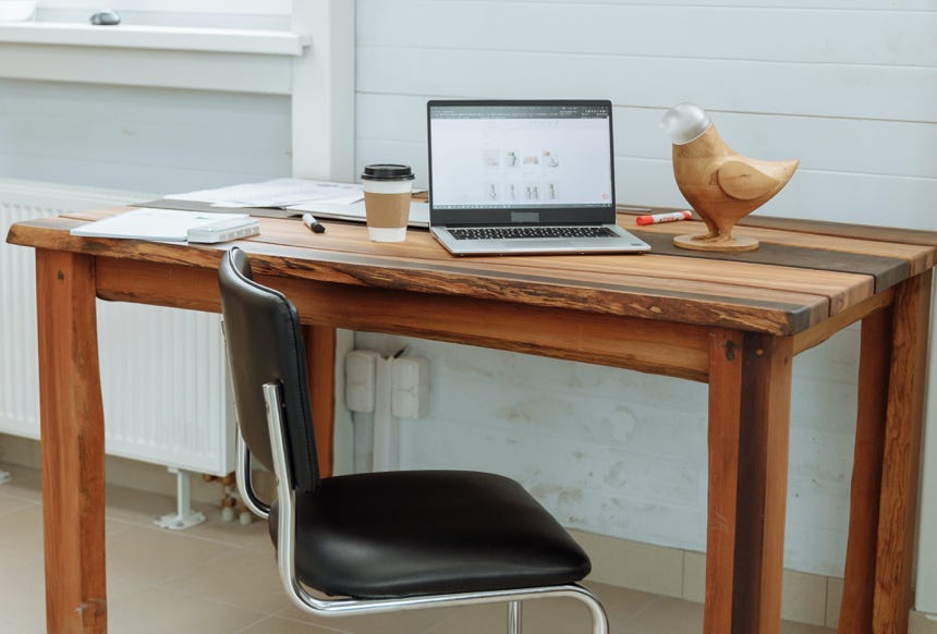 Computer on a Wooden Desk with the Designer's Business Website on the Screen